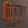 A collection of 14 professional makeup brushes and sponges in various shades of brown and bronze.
