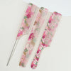 A set of dual pink and green floral hair combs for styling
