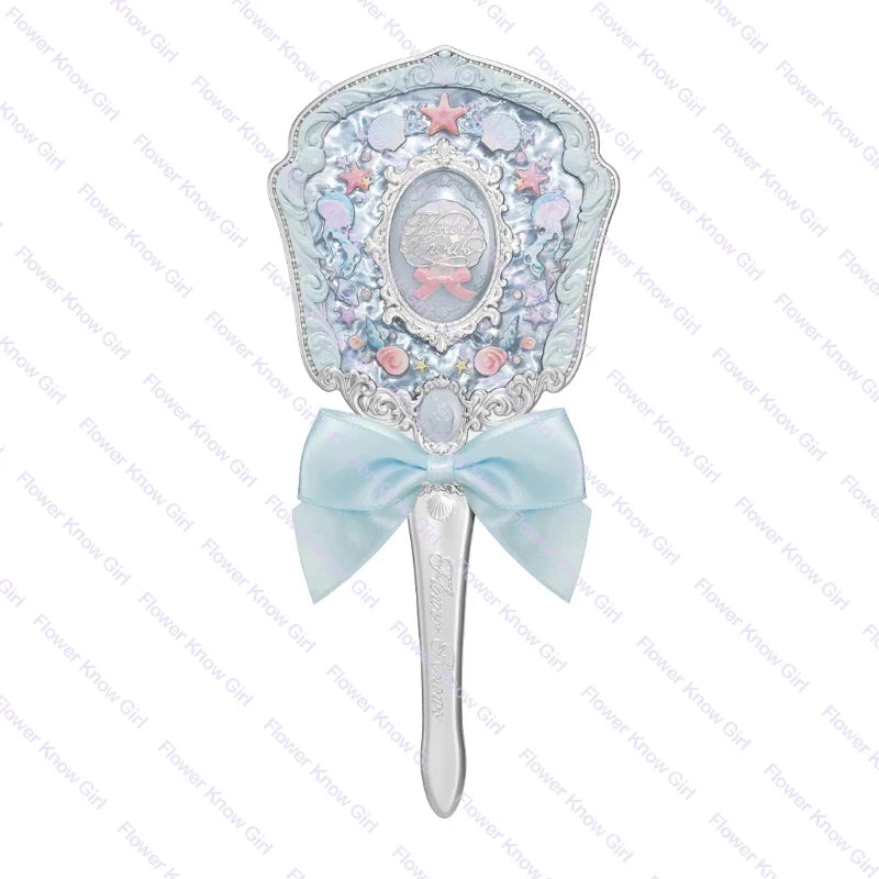 A light blue pearl hand mirror with a pink and silver design, featuring a ribbon bow.