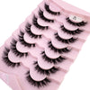 Plateau en plastique rose contenant divers styles de faux cils de renard noirs pour usage cosmétique.