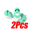 Two silicone noise-canceling earplugs in a mint green color displayed on a white surface.