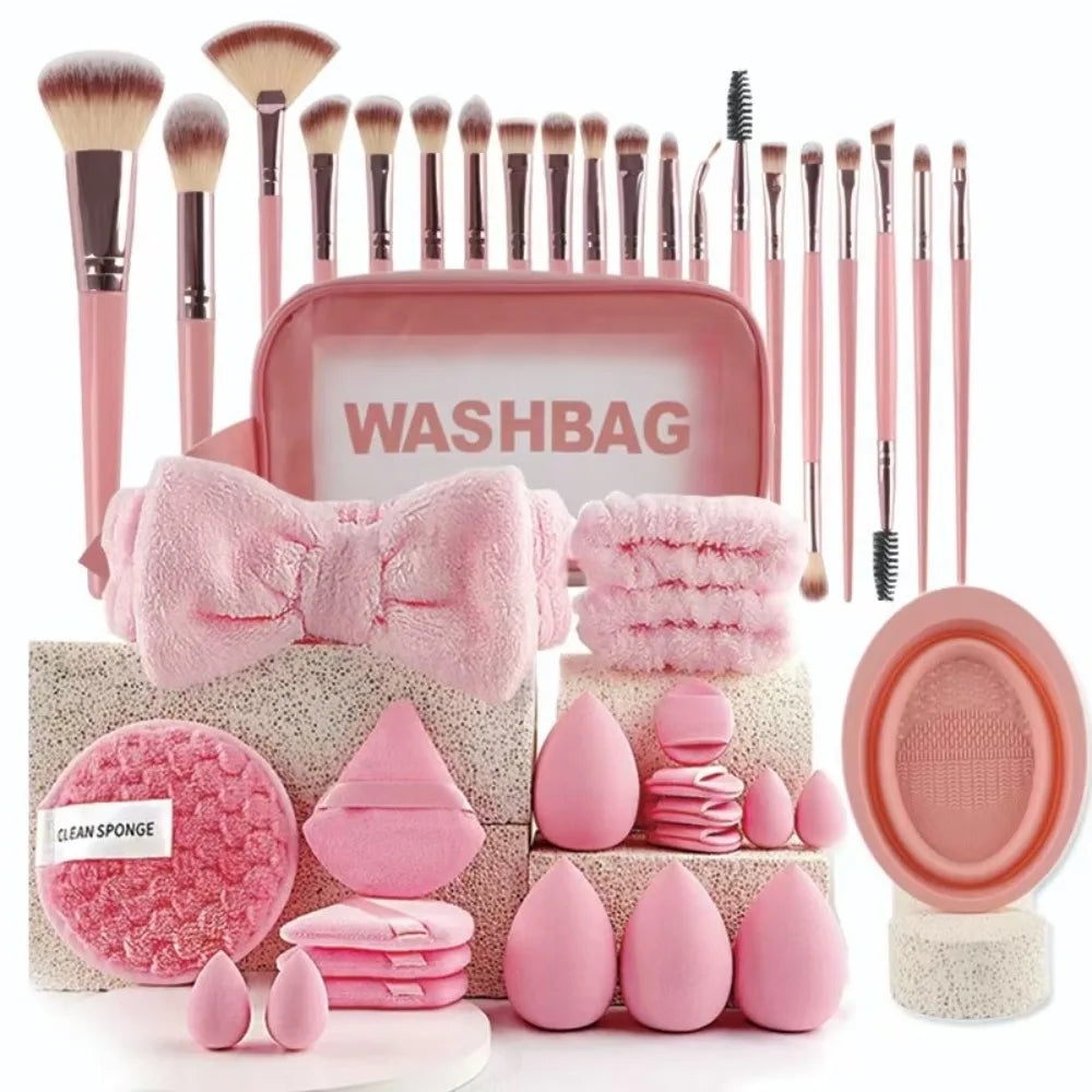A pink washbag set featuring makeup brushes, sponges, and tools for applying cosmetics.