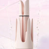 A close-up of a pink hair curling iron tool with dual negative ion emitters shown against a light background.