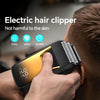 A hand is using an electric hair clipper on a man's head, demonstrating the product's use.