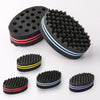 A set of dual-sided hair braiding brushes in black with pink and blue accents.