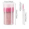 A clear container holding pink and black disposable eyelash and eyebrow makeup brushes.