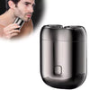A close-up of a sleek, black cordless electric razor shaver being held by a man.