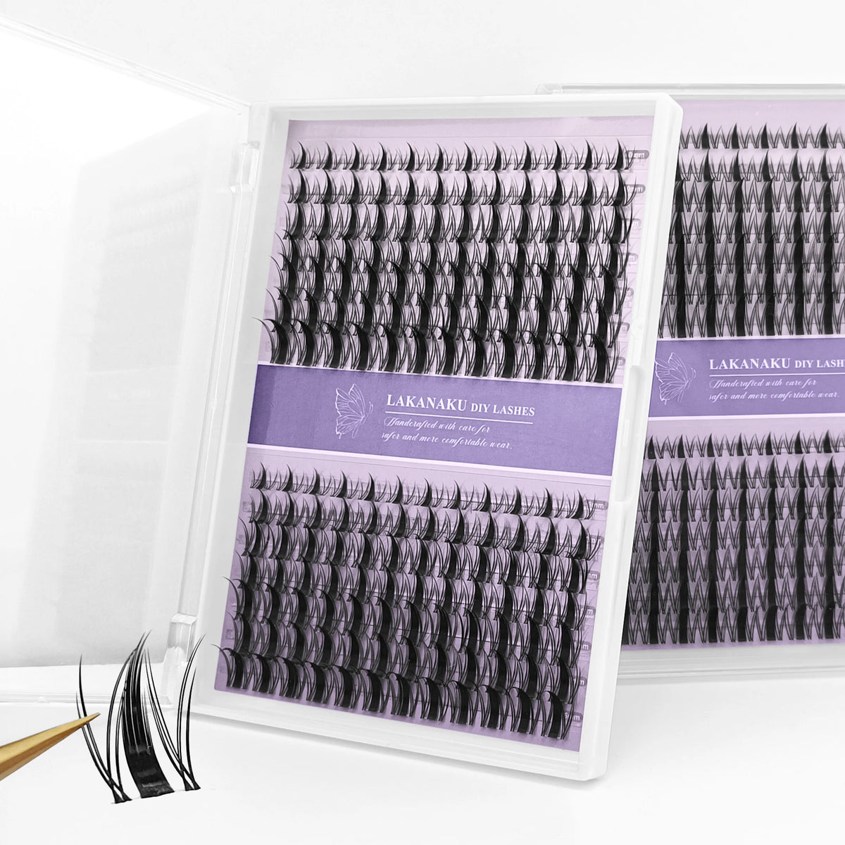 A display of black manga style invisible bond eyelashes in a clear packaging box.