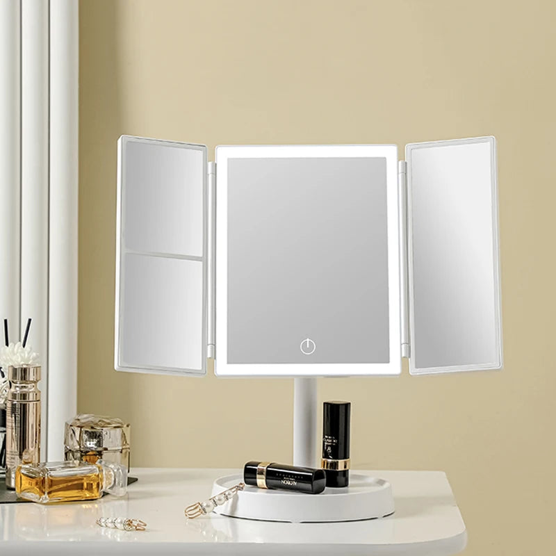 A foldable LED makeup mirror with magnification displayed on a white table.