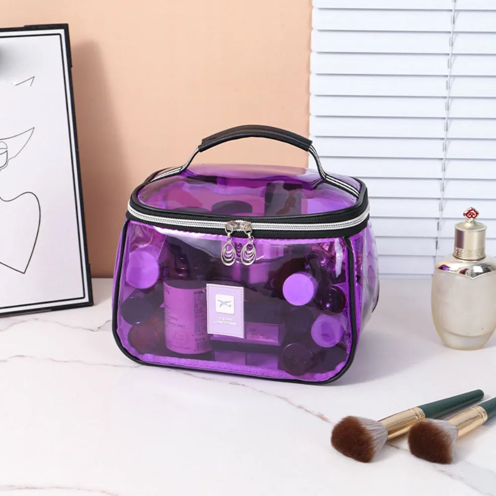 A purple clear PVC cosmetic bag with a zipper containing various beauty products is displayed on a white surface.