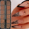 A close-up of gold mixed stainless steel bead nail art decorations applied to fingernails.