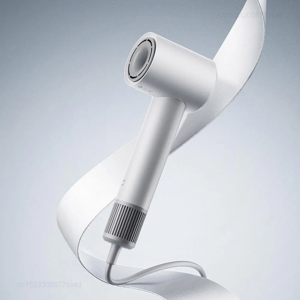 A white professional high-speed hair dryer is shown in a close-up, angled view against a light gray background.