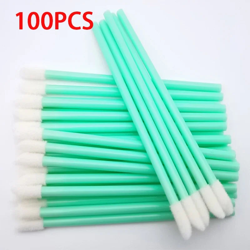 A set of 100 precision makeup brushes with light green handles and white bristles.