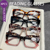 A white box containing four pairs of tortoiseshell reading glasses with various lens additions.