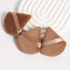 A set of three triangular cosmetic powder puffs in a warm brown suede texture with satin ribbon accents.