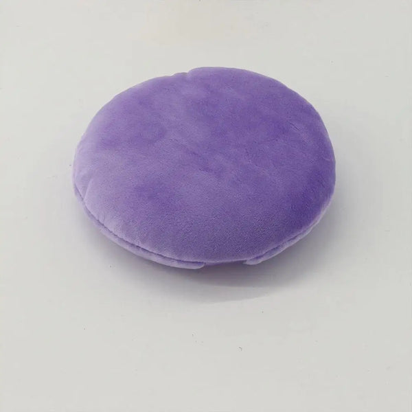 A round, purple jumbo soft powder puff used for flawless makeup application.