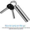 A silver metal keychain with a hook and a toothpick attached.