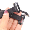 A hand holds a black facial lifting band with adjustable straps for anti-wrinkle support.