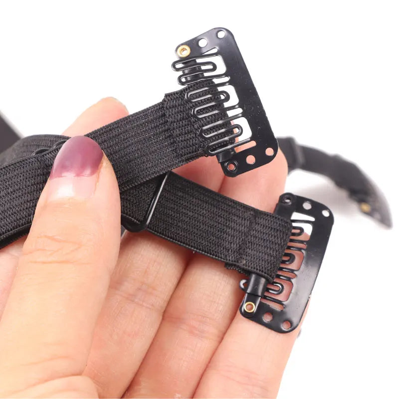A hand holds a black facial lifting band with adjustable straps for anti-wrinkle support.