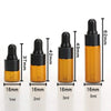A set of five amber glass dropper bottles with black caps and various volume markings, showing different sizes.