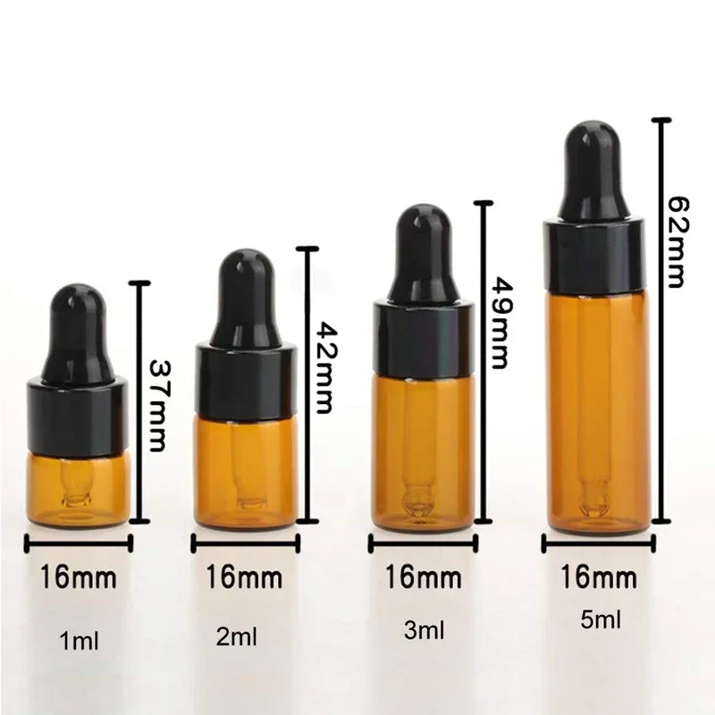 A set of five amber glass dropper bottles with black caps and various volume markings, showing different sizes.