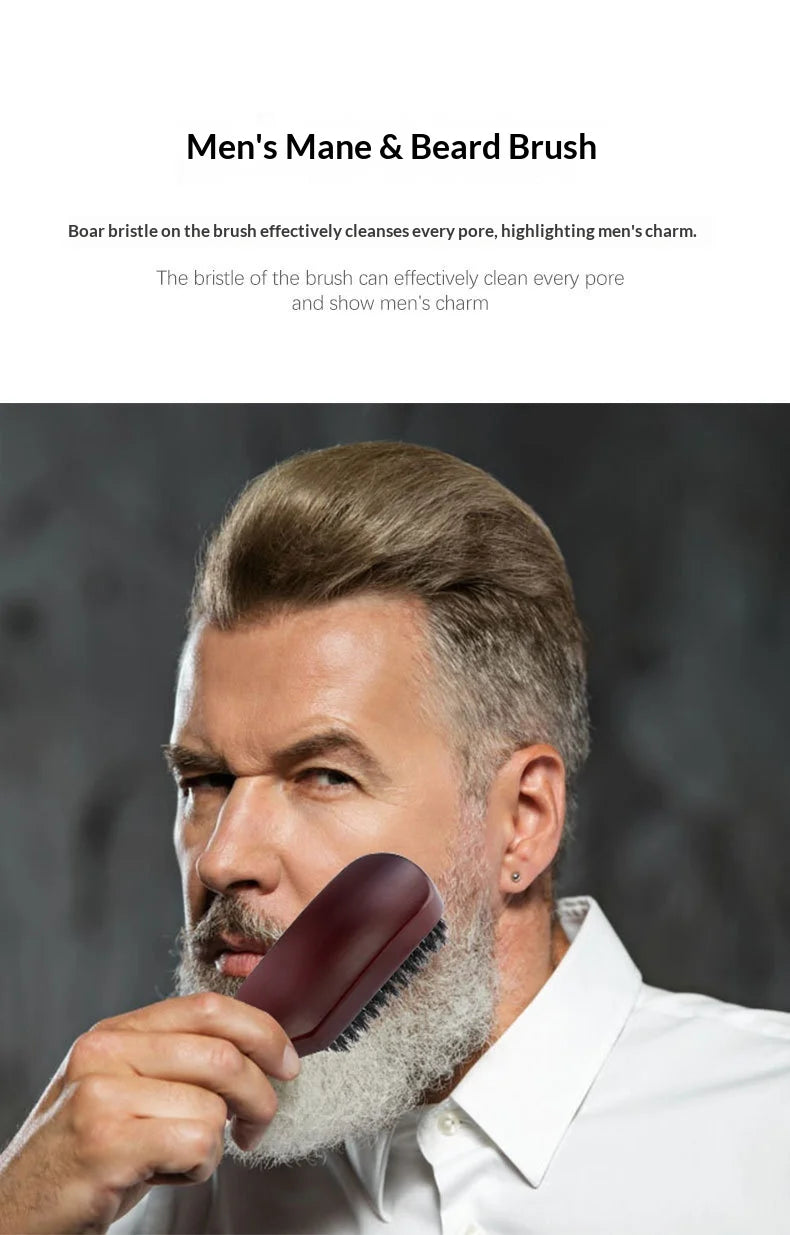A man is holding a dark wooden boar bristle hair and beard brush near his face.