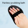 A hand is using a black silicone scrubbing bath tool on its fingers.