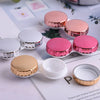 A collection of round contact lens storage boxes in pink and gold colors displayed on a white background.