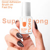 A hand holds a bottle of Super Strong Nail Glue with a brush-on applicator and several press-on nails.