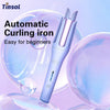 A close-up of a purple automatic curling iron with a pink barrel, shown against a background of translucent spheres.