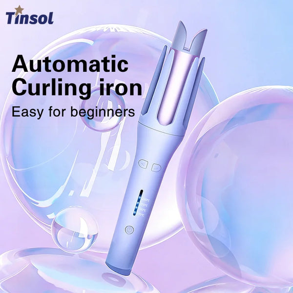 A close-up of a purple automatic curling iron with a pink barrel, shown against a background of translucent spheres.