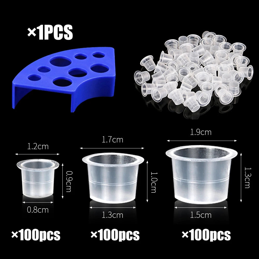 Set of tattoo ink cups including a blue holder and three sizes of clear disposable cups