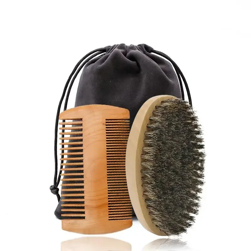 A set of boar bristle beard brush and comb in light wood with a black fabric gift bag.