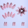 A set of press-on nails featuring a pink base with a flower and star design pattern.