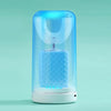 A clear electric toothbrush with a blue light glows inside, resting on a white base.