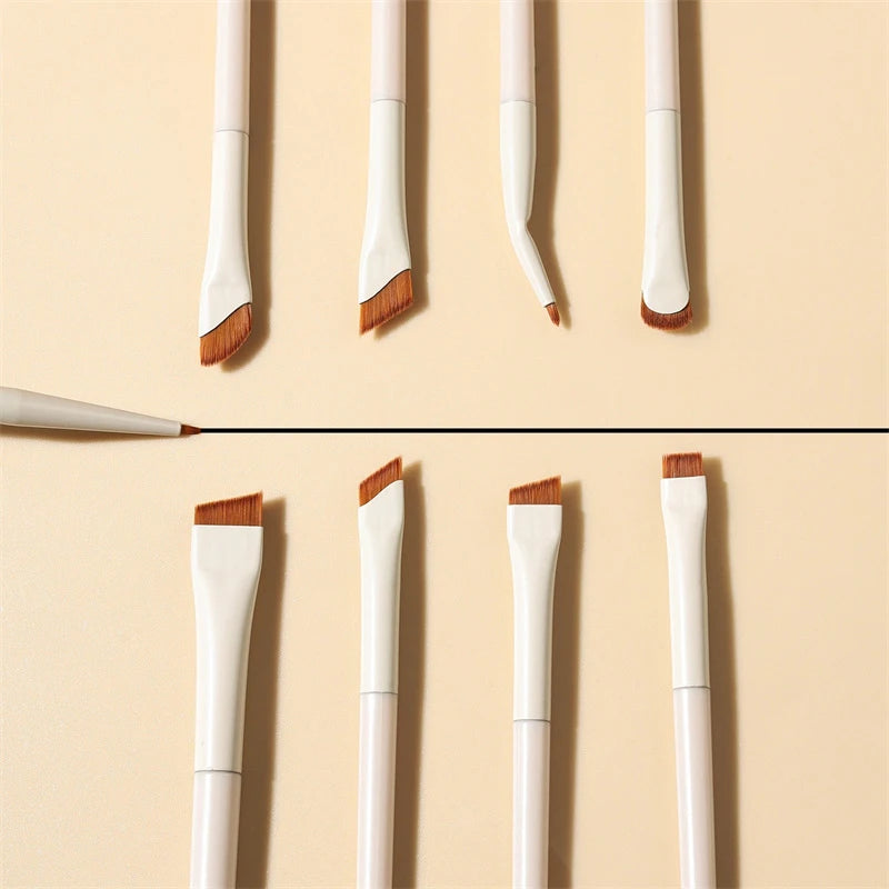A set of precision angled eyeliner and eyebrow makeup brushes with white and wooden handles displayed vertically.