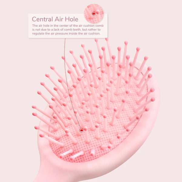 A pink cartoon mini air cushion massage comb with a central air hole shown on a light background.