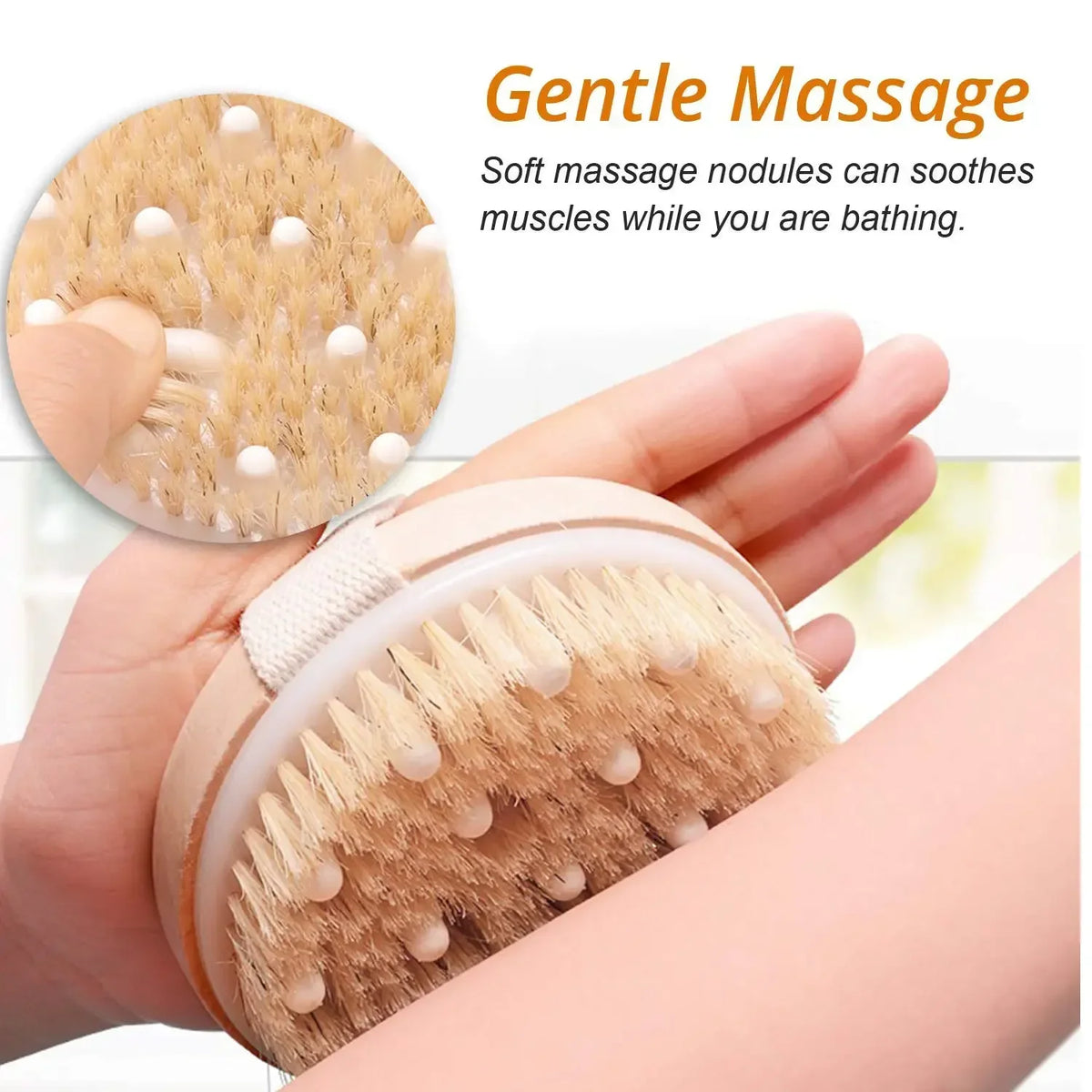 A hand is holding a natural dry brushing body scrub brush with bristles and massage nodules.