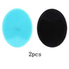 Two silicone facial cleansing brushes, one blue and one black, for deep pore cleansing.