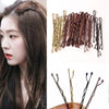A collection of 100 metal U-shaped hair pins in various shades of brown and gold for hair styling.