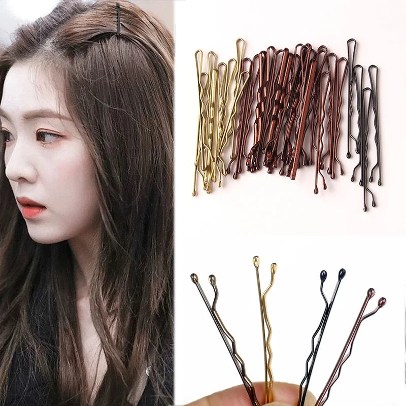 A collection of 100 metal U-shaped hair pins in various shades of brown and gold for hair styling.