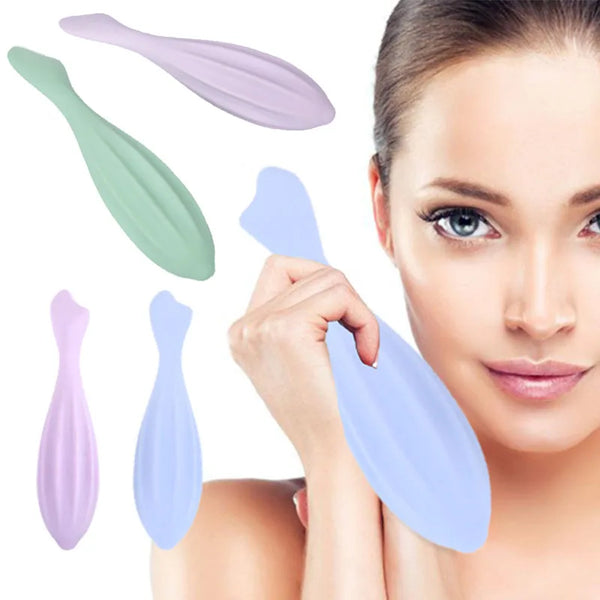 A woman is holding several silicone gua sha rollers of various shades, including green, purple, and blue, near her face for f