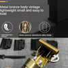Close-up of a gold metal bronze vintage lightweight hair shaver trimmer with a black handle and white cord.