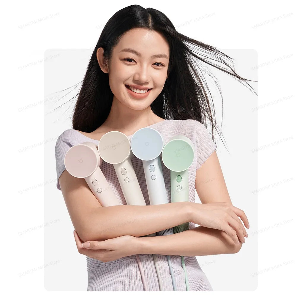 A woman holds a professional high-speed hair dryer with multiple color attachments.