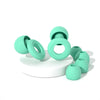 A collection of light green silicone earplugs in various sizes and shapes for noise cancellation.