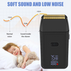 A black electric beard and hair trimmer is shown next to a child sleeping peacefully.