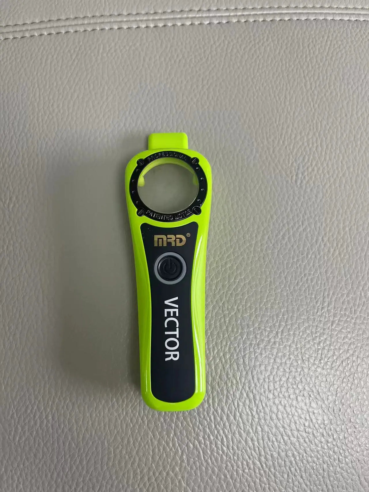 A bright lime green professional electric hair trimmer with a black handle and circular opening.