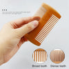 A hand holds a wooden beard comb, demonstrating the difference between broad teeth and dense teeth.