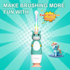 A green and white electric toothbrush with a unicorn-themed handle is shown against a light blue background.