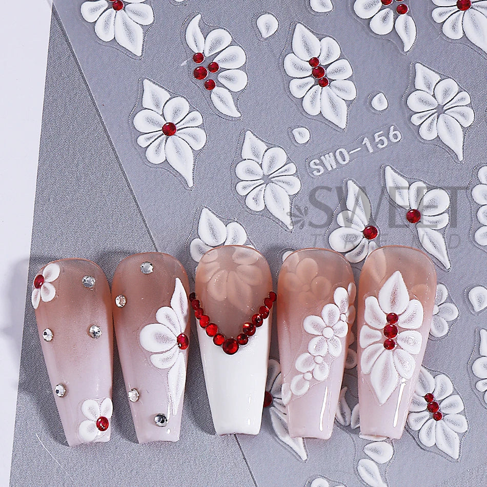 A set of two embossed white floral nail stickers featuring pink and red accents on a gray background.